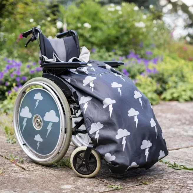 Wheelchair in garden with wheelchair cosy in grey and silver lightening design