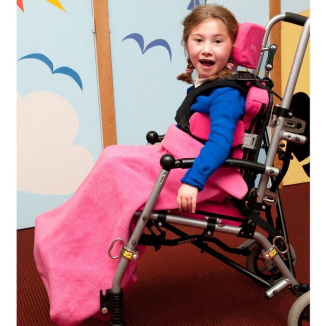 Girl in wheelchair wearing Pink Fleece Leg Cover