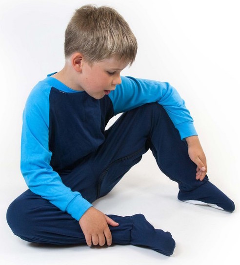 Boy sitting on the floor wearing navy turquoise zip back sleepsuit