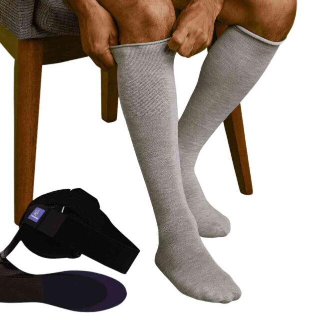 Man sat on chair wearing knee length AFO socks