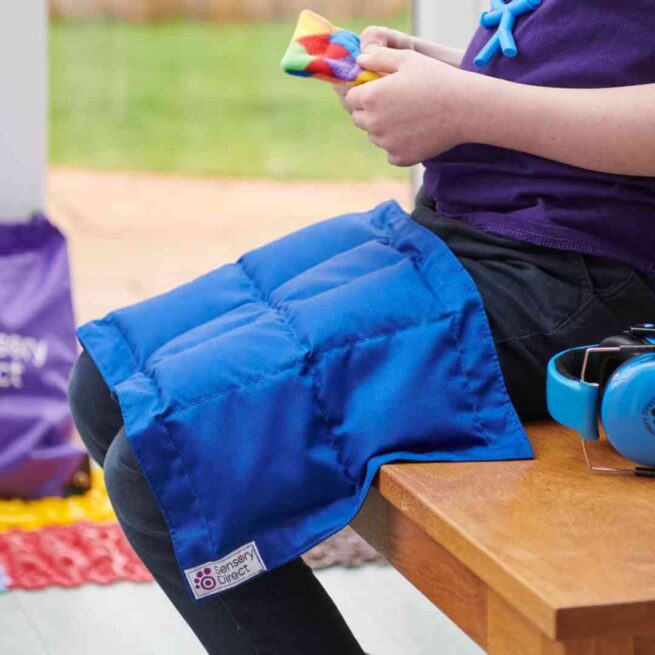 Boy with weighted lap pad in blue