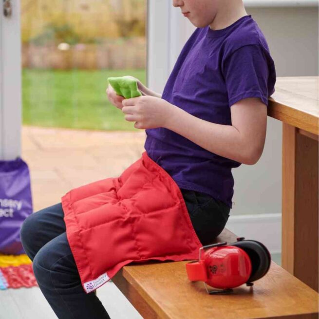 Boy with weighted lap pad in red