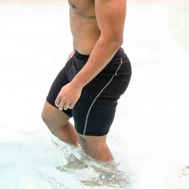 Man in swimming pool wearing Splash About Jammer Shorts in black