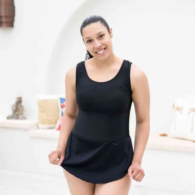 Woman wearing black swimming costume with skirt