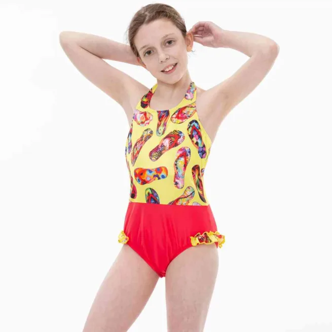 Girl wearing Kes Vir incontinence swimsuit in marigold and coral colour with flip flop design