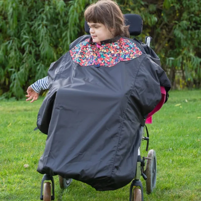 Girl wearing a total wheelchair cover in print mix design