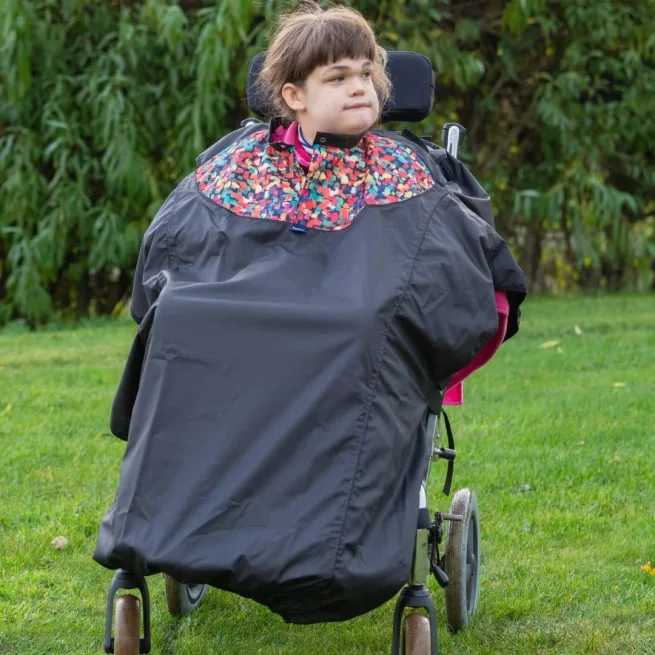Girl wearing a total wheelchair cover in print mix design