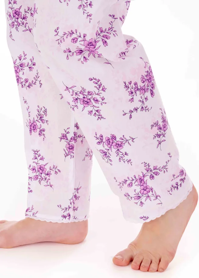 Pyjamas bottoms in plum floral design. Bare feet showing