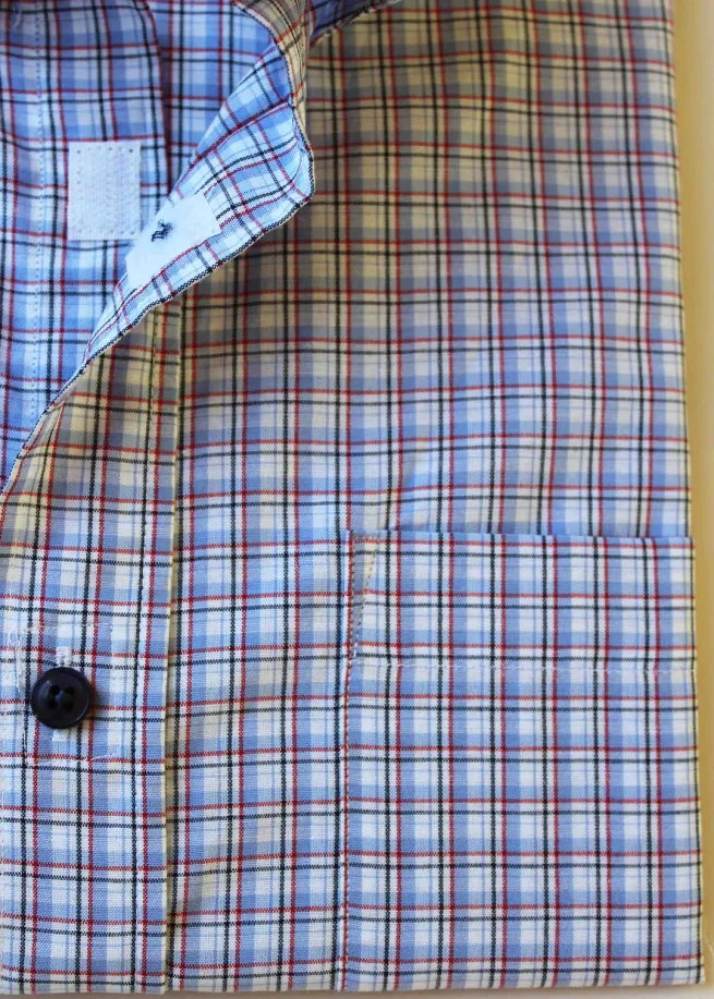 Close up of button and velcro fastening on men's Douglas short sleeve check shirt