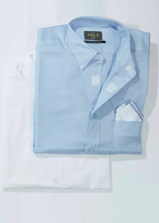 Image of folded plain white and light blue shirts on white background