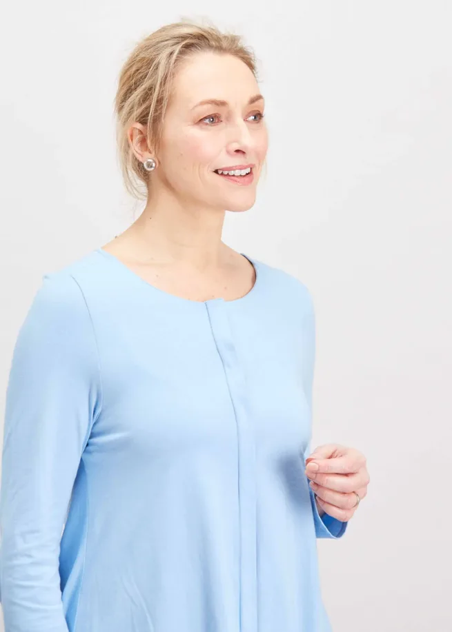 Woman wearing The Able Label seaspray blue top