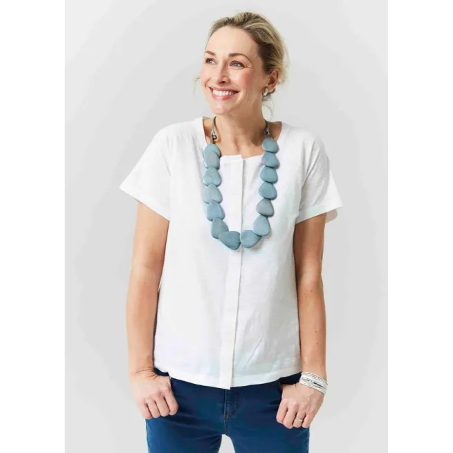 Woman wearing white short sleeve tee with seaspray necklace