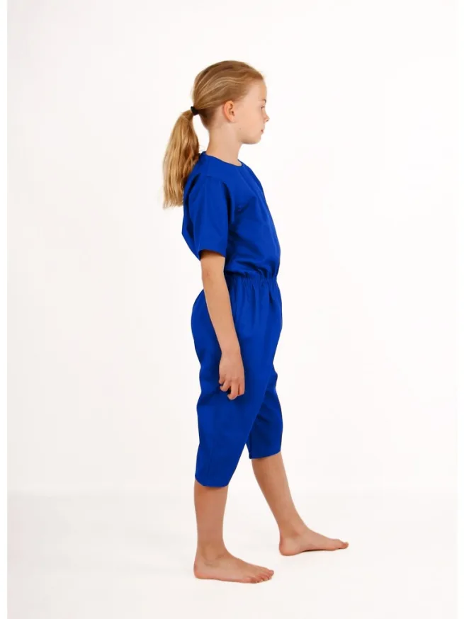 Girl standing wearing royal blue rip resistant bodysuit, short sleeves, knee length, side view