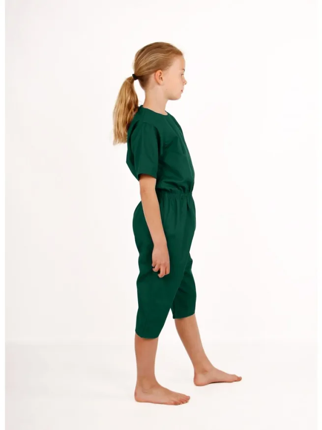 Girl standing wearing green rip resistant bodysuit, short sleeves, knee length, side view