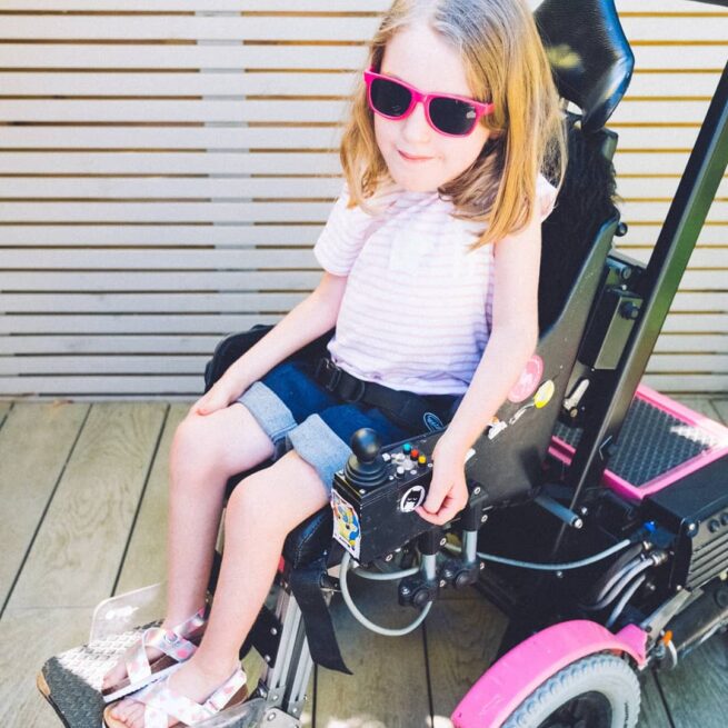 Girl wearing wheelchair shorts in denim